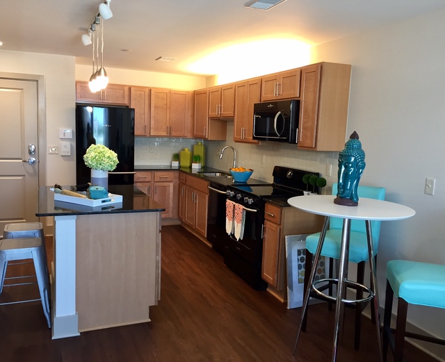 Orleans Landing - Kitchen with hard wood floors and granite countertops