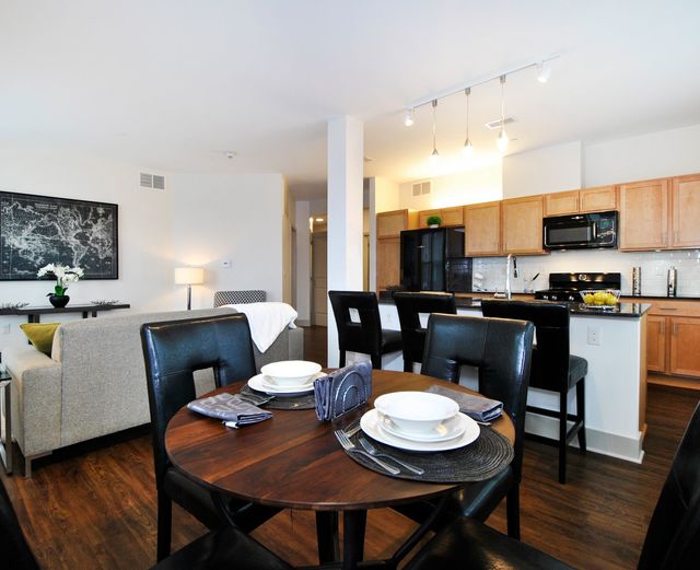 Orleans Landing - Open kitchen and dining room/living area with lots of natural light and dark hard wood floors throughout